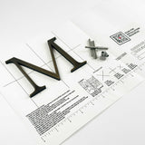Heavily aged solid bronze division 10 architectural sign letter on mounting template with hardware