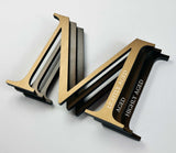 Solid bronze sign letters comparing lightly aged, aged, and highly aged finishes