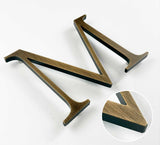 Aged solid bronze division 10 architectural sign letter with finish closeup