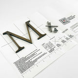 Aged solid bronze division 10 architectural sign letter on mounting template with hardware