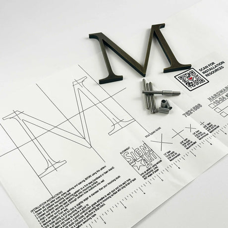Aged solid bronze division 10 architectural sign letter on mounting template with hardware