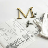 Polished solid bronze division 10 architectural sign letter on mounting template with hardware