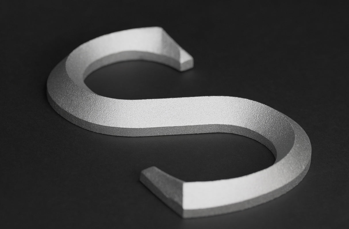 Prismatic faced cast aluminum sign letter