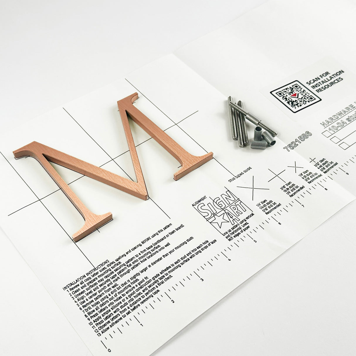 Vertically brushed solid copper division 10 architectural sign letter on mounting template with hardware
