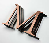 Comparison of solid copper division 10 architectural sign letters with light, medium, and high levels of aging