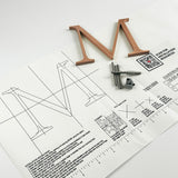 Orbitally brushed solid copper division 10 architectural sign letter on mounting template with hardware