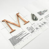 Random arc brushed solid copper division 10 architectural sign letter on mounting template with hardware