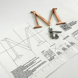 Random arc brushed solid copper division 10 architectural sign letter on mounting template with hardware