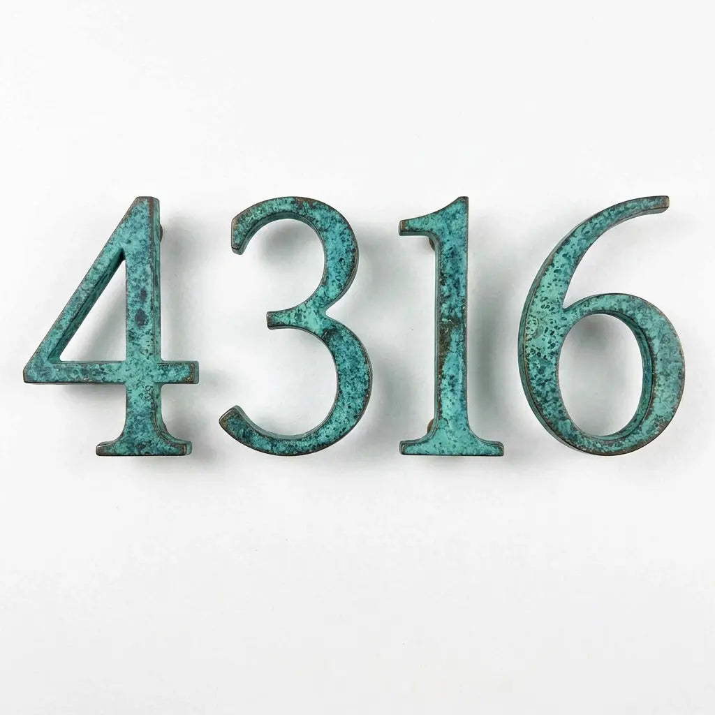Bronze house numbers with a verdigris turquoise patina