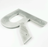 Solid aluminum sign letter animating installation of back studs and spacers