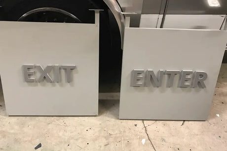 Exit and enter signs with cast aluminum sign letters