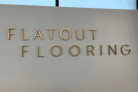 Cast bronze sign letters for Flatout Flooring