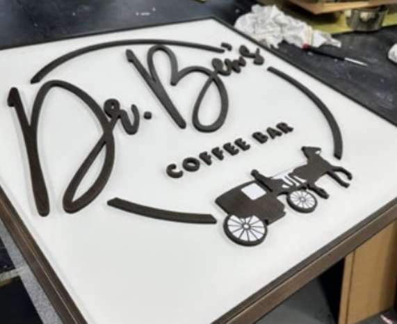 Coffee shop sign composed of aged flat cut bronze sign letters